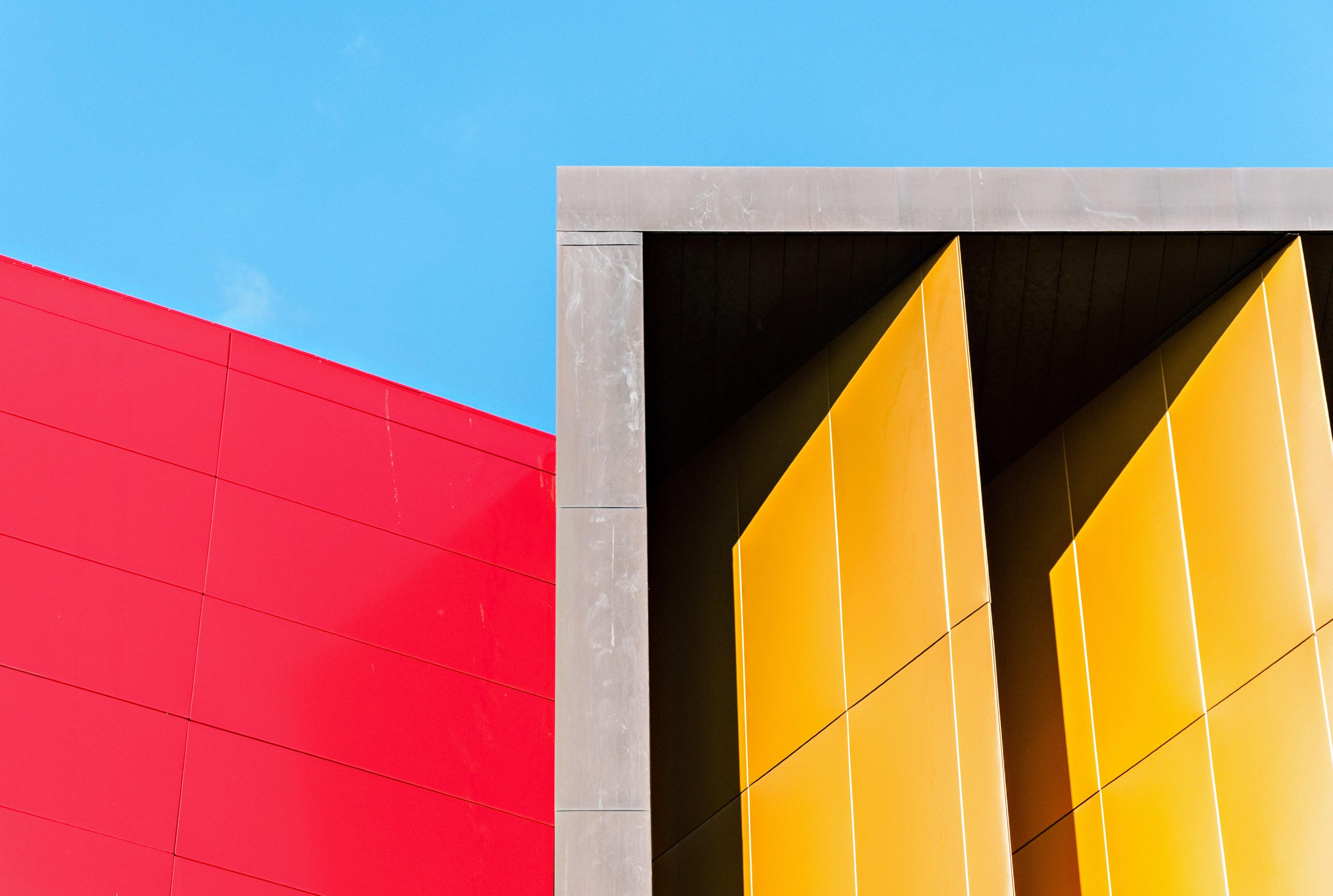 Red and yellow abstract loft architecture against blue sky