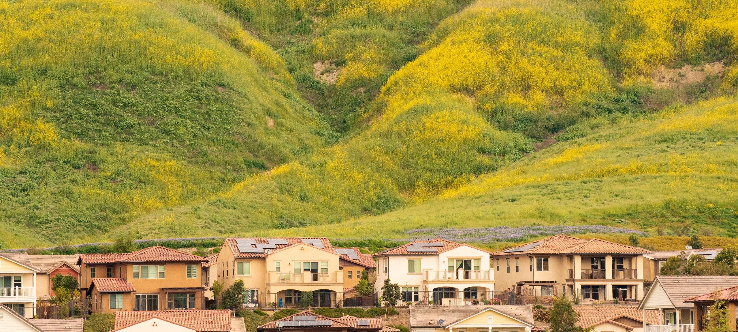 Green and yellow hillside with homes in Rancho Mission Viejo, CA