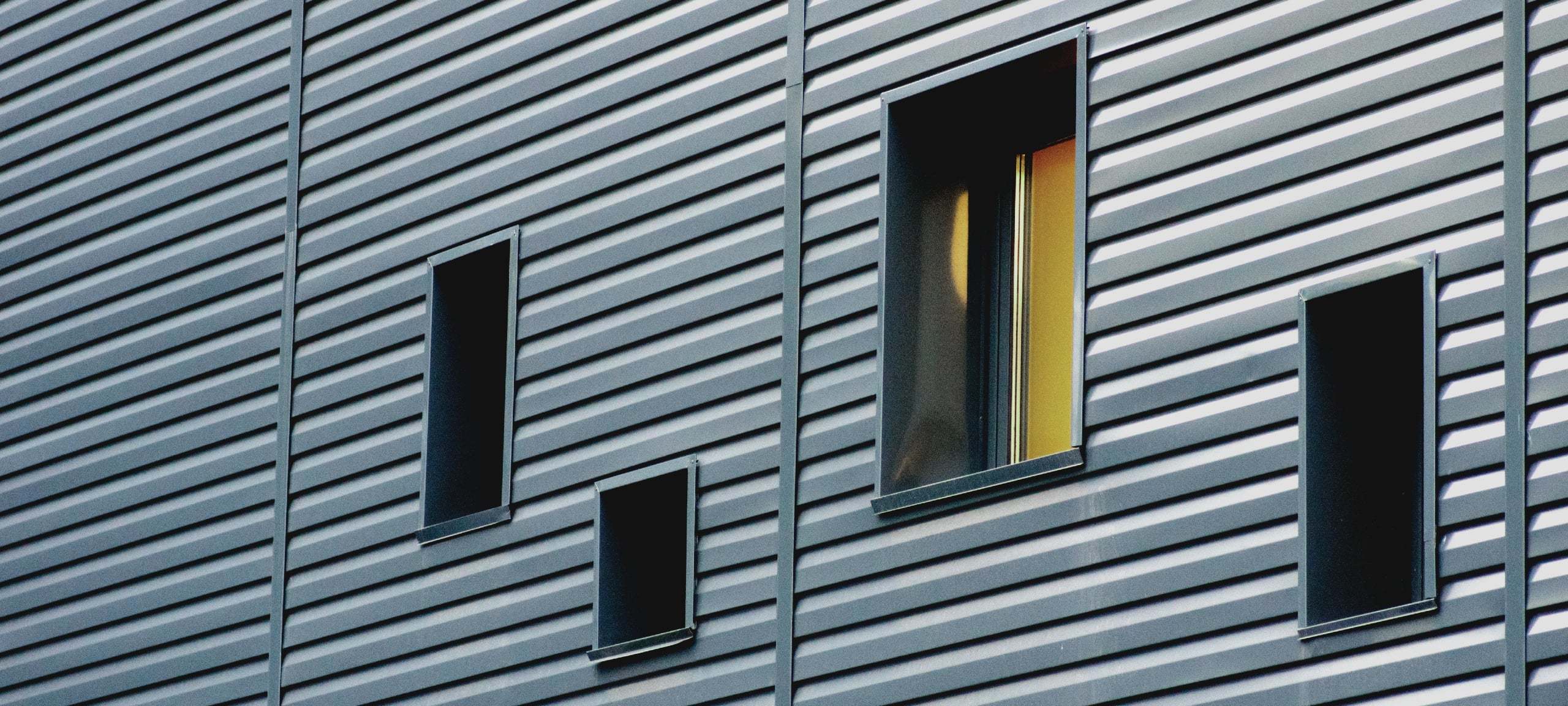 Gray abstract loft siding and small windows
